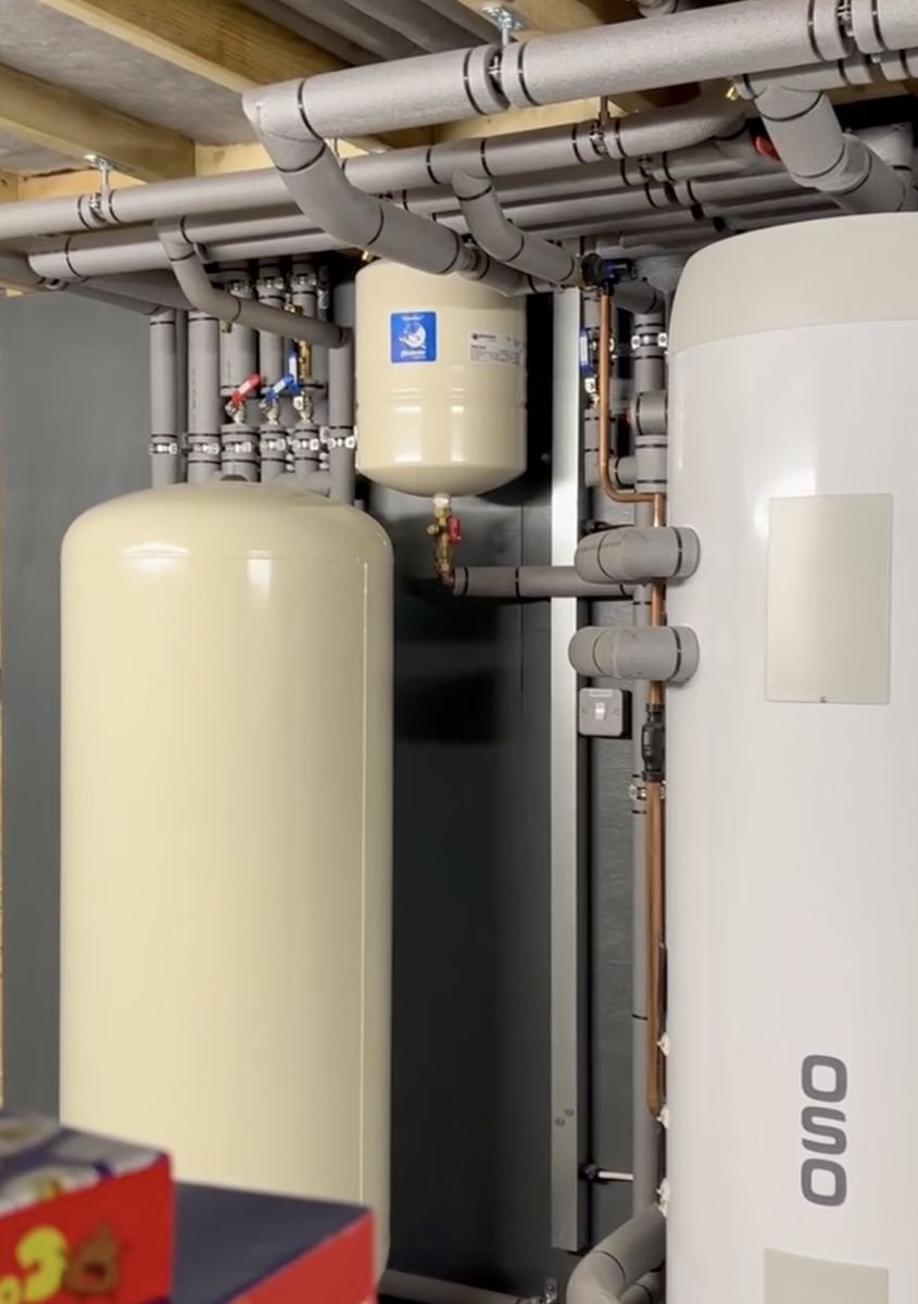 Buffer tank and unvented hot water cylinder with insulated pipework