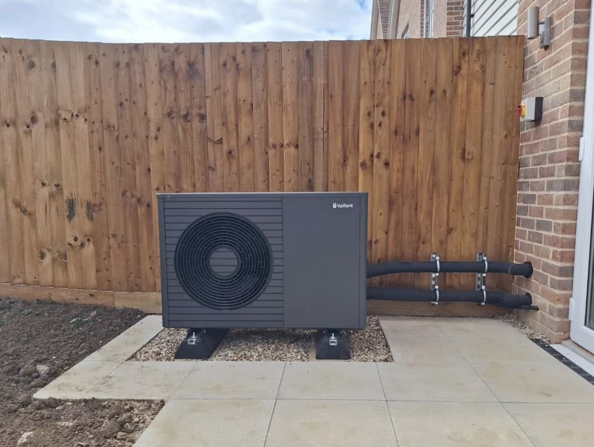 Vaillant aroTHERM plus air source heat pump on a gravel bed beside a new-build home