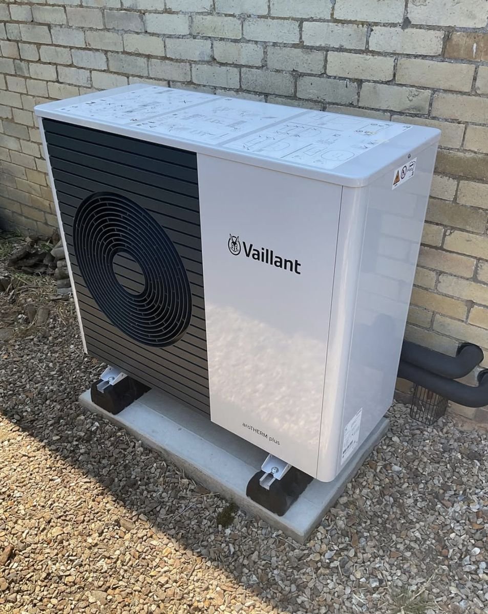 Vaillant aroTHERM plus on a concrete base surrounded by gravel